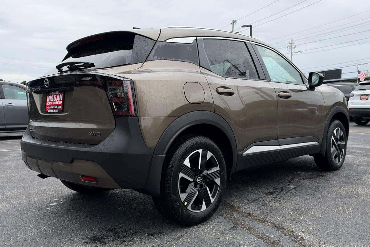 Passenger side rear three-quarter view of a 2027 Nissan Kicks in Canyon Bronze Metallic at Nissan of North Olmsted