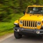 Yellow 2021 Jeep Wrangler Driving through Forest