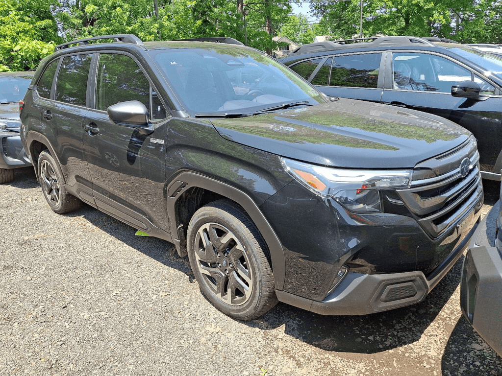 A 2025 Subaru Forester parked at a dealership lot on a sunny day.