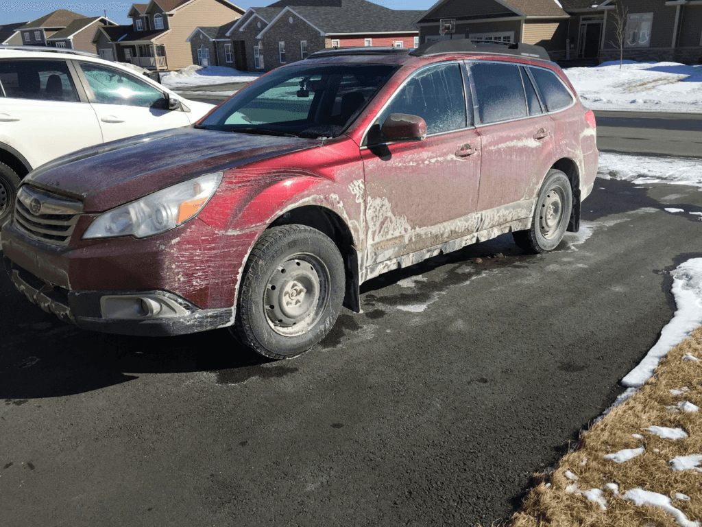Subaru covered in road salt