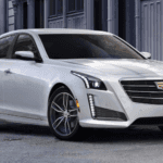 white cadillac cts in city street
