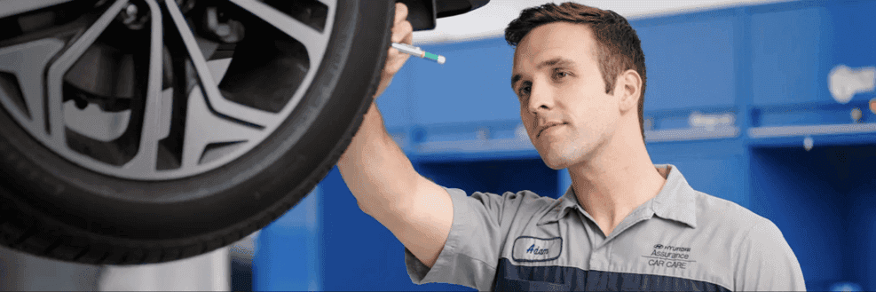 Hyundai Mechanic Inspecting Tires