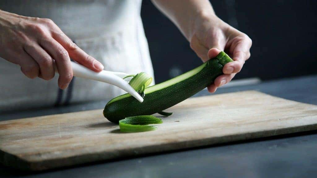 chef cutting a cucumber