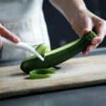chef cutting a cucumber