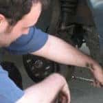 mechanic checking brakes