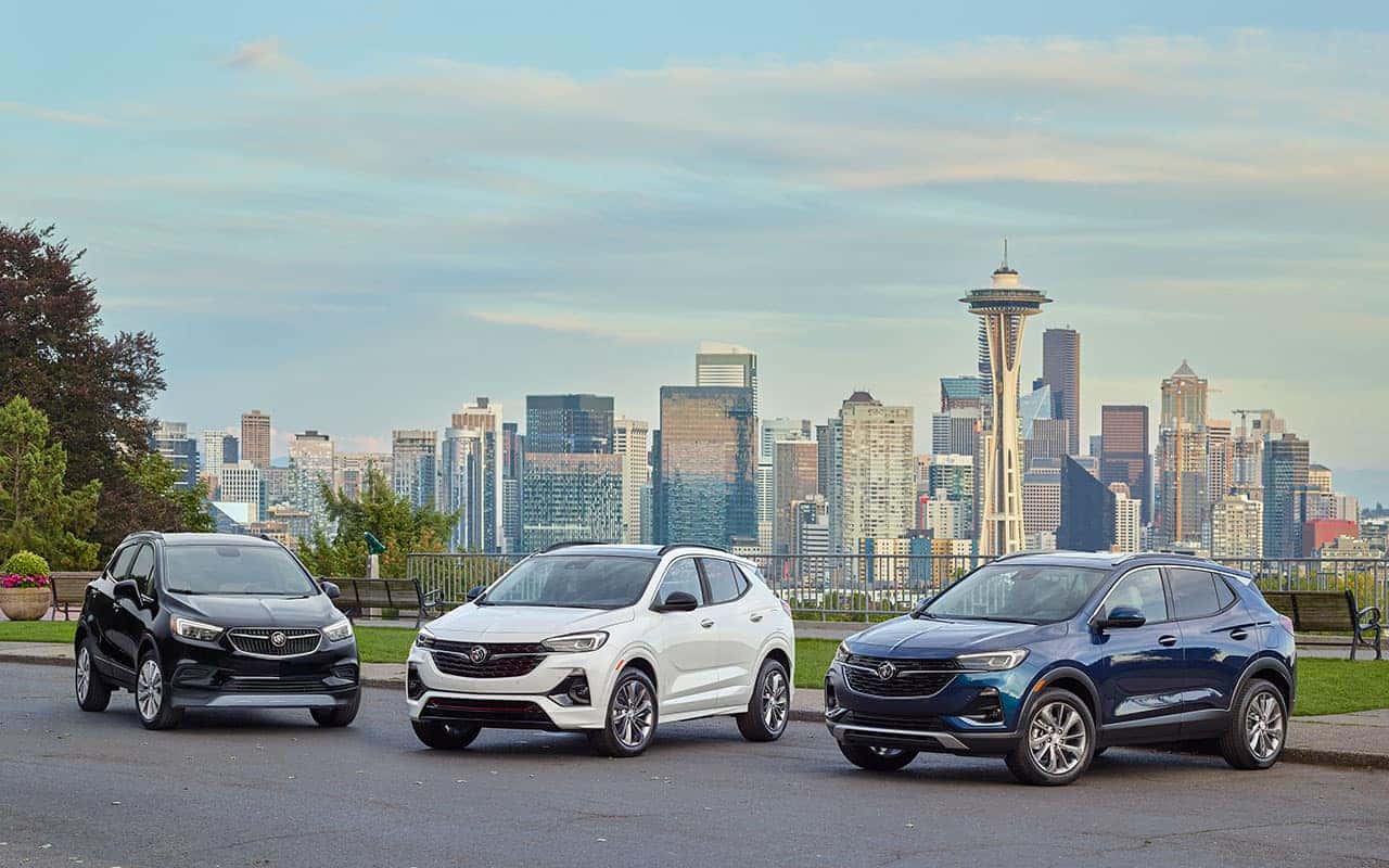 Left to Right. 2021 Encore GX Essence (1SL) exterior in SATIN STEEL METALLIC. Shown with RQJ wheels, Sport Touring Package, and Convenience Package. 2021 Encore GX Essence (1SL) exterior in WHITE FROST TRICOAT. Shown with RQJ wheels, Sport Touring Package, Convenience Package and Black Roof Package. 2021 Encore GX Essence (1SL) exterior in DEEP AZURE METALLIC. Shown with RQK wheels, Experience Buick Package and Convenience Package.