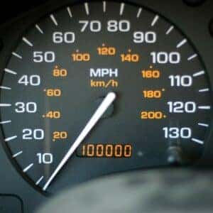 A speedometer of a car also showing 100,000 miles