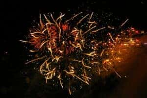 Bright Fireworks going in several directions in the night sky