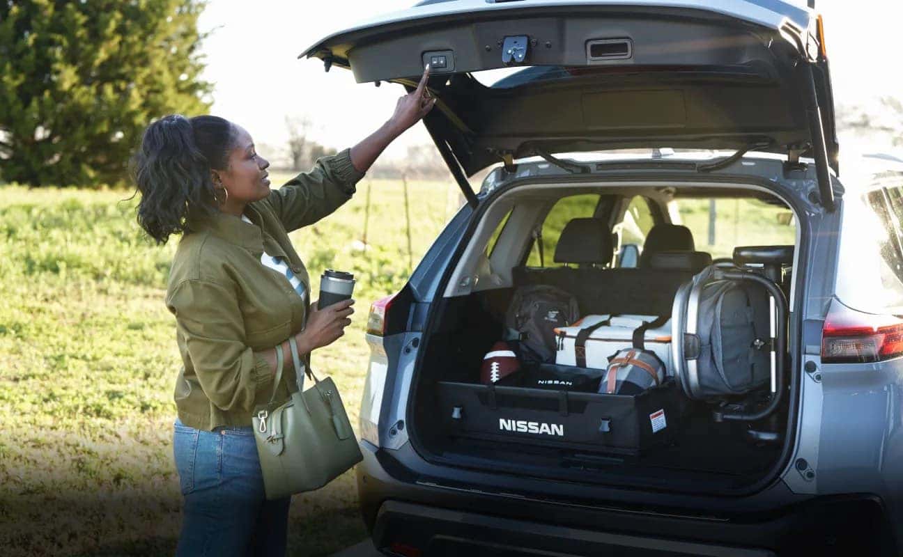 Nissan owner loading a vehicle for a trip after dependable Nissan service