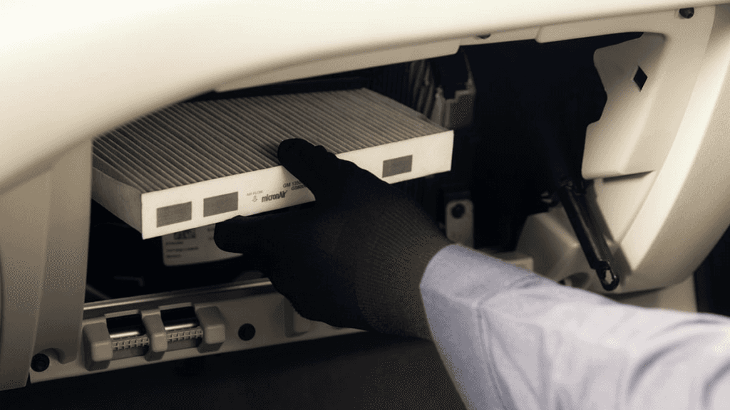 A technician replacing a cabin air filter