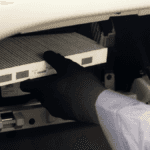 A technician replacing a cabin air filter