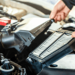 A technician removing an old engine air filter
