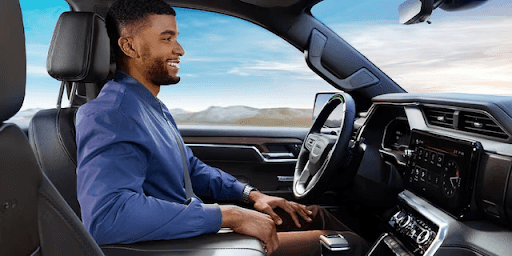 Man sitting behind steering wheel