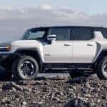 GMC HUMMER EV SUV side view on cliff