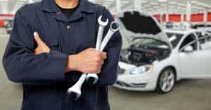 Mechanic in front of the car