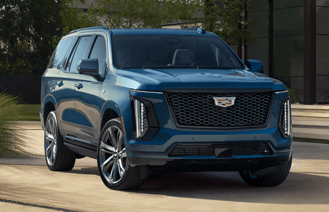 Blue Cadillac Escalade ESV parked in drive way